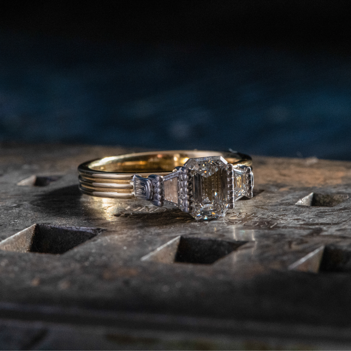 Close up of yellow gold ring with emerald cut diamonds