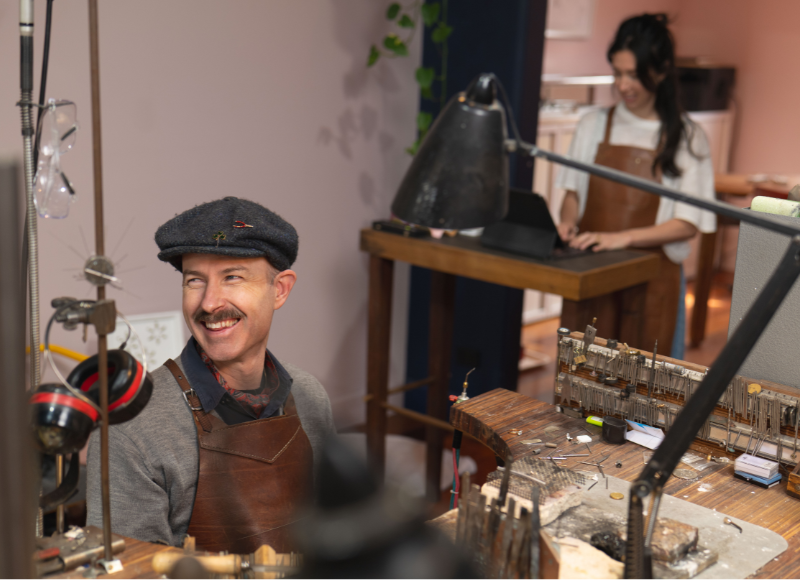 Jewellers in Olinda workshop sharing a laugh while making a bespoke piece.
