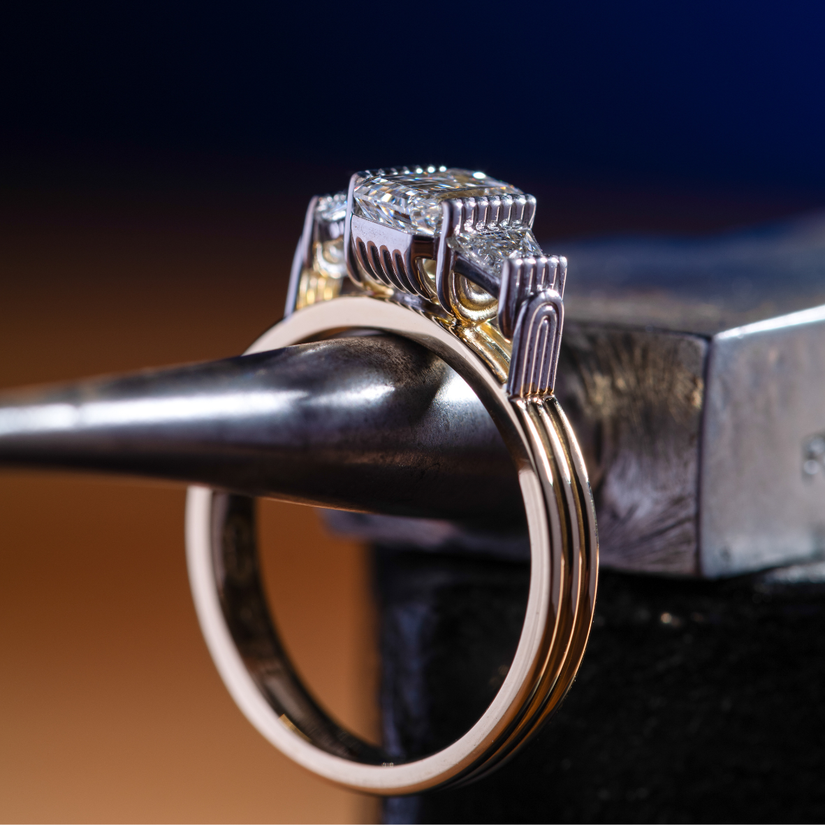 Close up of yellow gold ring with emerald cut diamonds