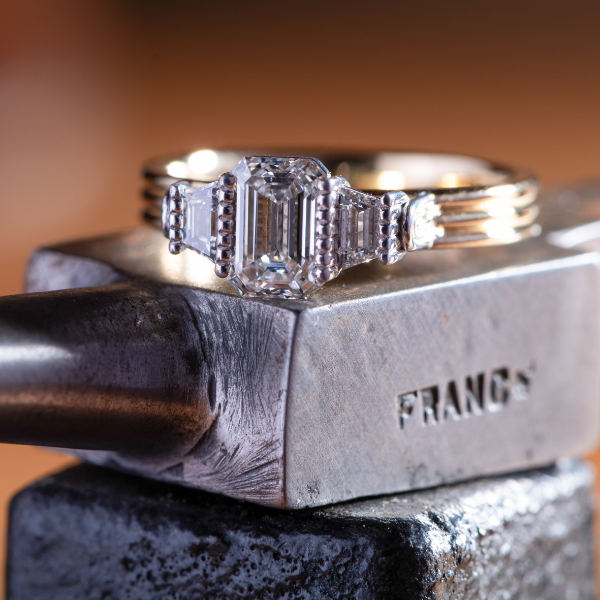 Close up of yellow gold ring with emerald cut diamonds