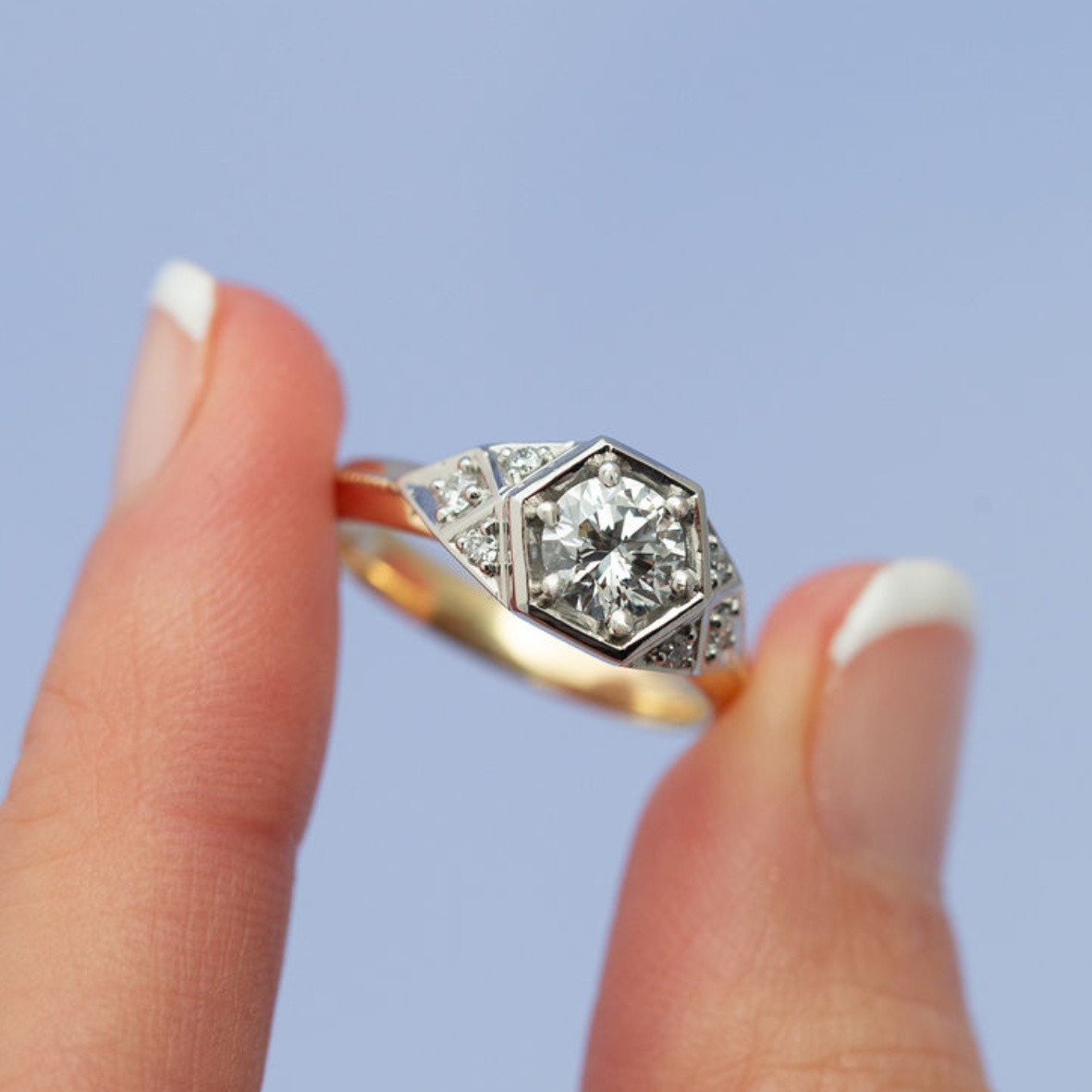 Maeve 05 Diamond ring on a finger with a clear background