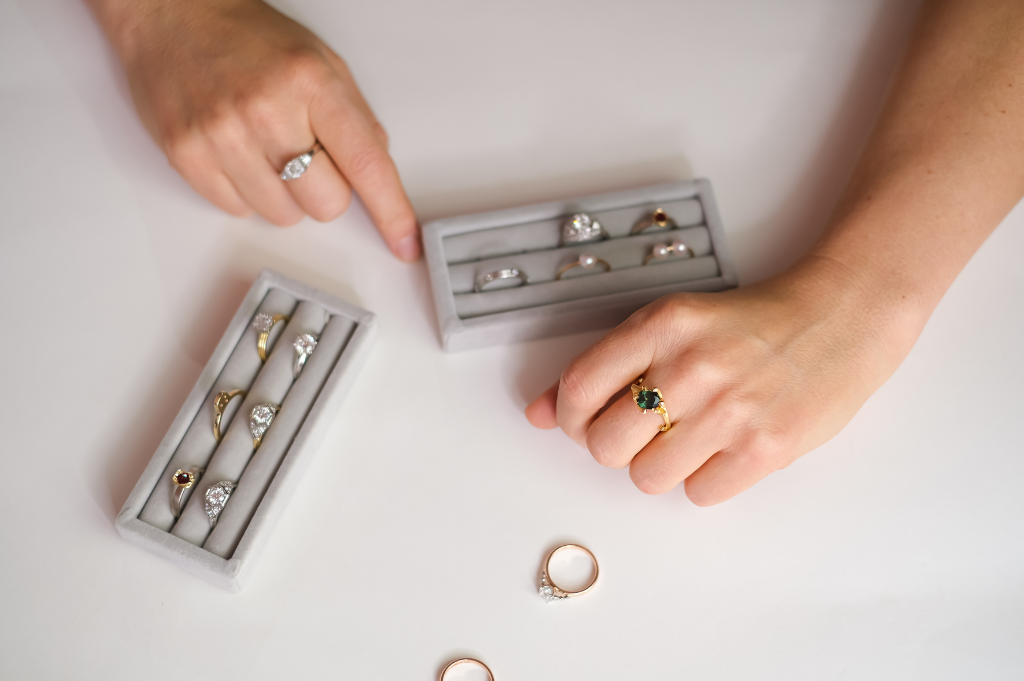 Lady wearing a custom made ring with a collection of handcrafted Art Deco rings by Terry Cockrem.