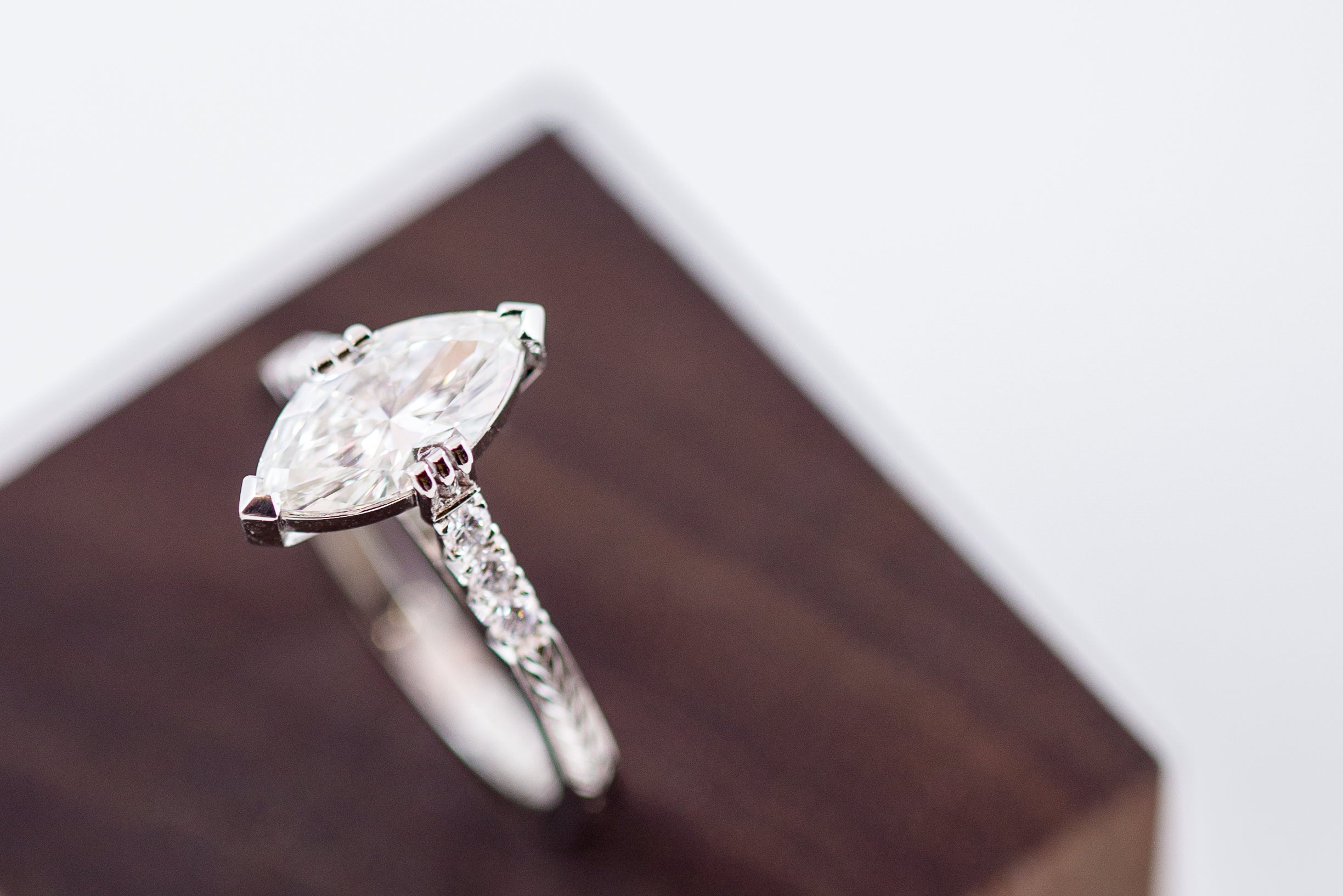 Close up of a platinum ring with a marquise cut diamond