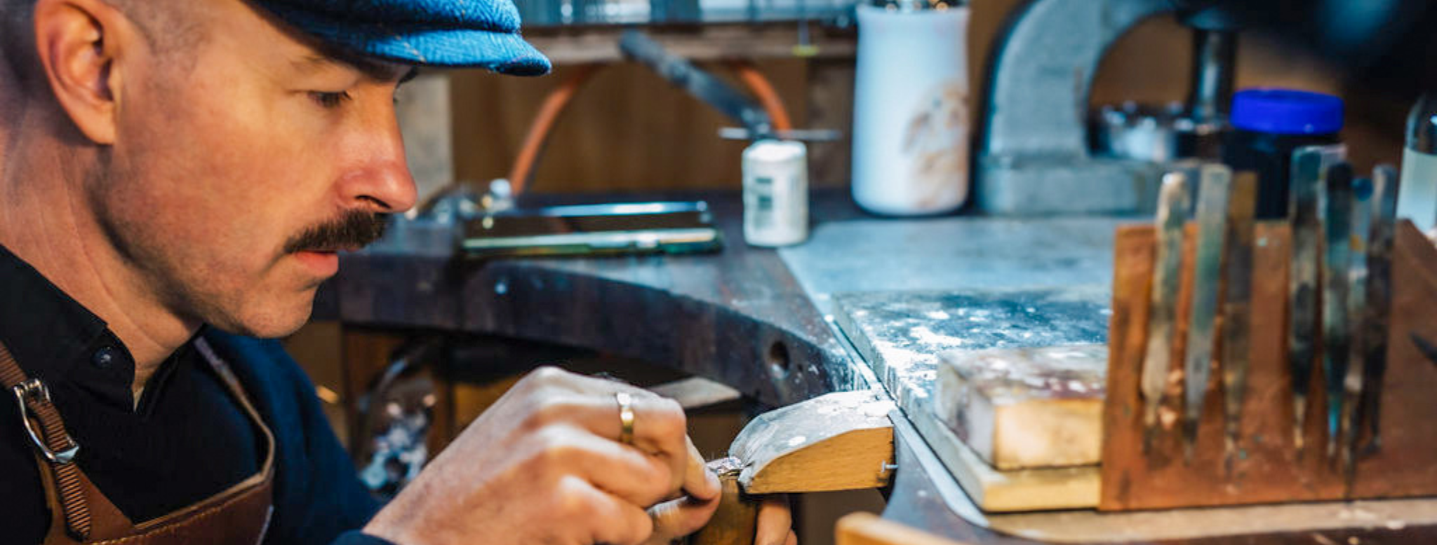 photo of jeweller working in his workshop on a custom ring